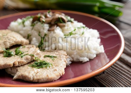 Pork loin fillets with rice and mushrooms