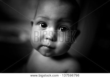 Face of a sad boy in black and white color