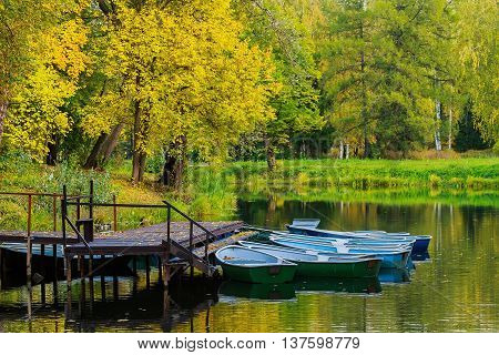Boats on the lake in the autumn forest. Russian Nature Yellow leaves in September