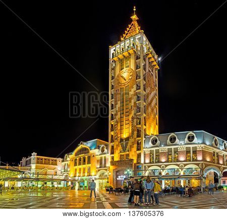 BATUMI GEORGIA - MAY 24 2016: The high clock tower of Piazza Inn located on the Piazza Square and surrounded by outdoor cafes and souvenir shops on May 24 in Batumi.