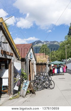 GERANGER, NORWAY - JUNE 29: Tourists enjoying the beautiful weather walking through the streets of Geiranger on June 29, 2016 in Geiranger, Norway. Geiranger is UNESCO heritage site.