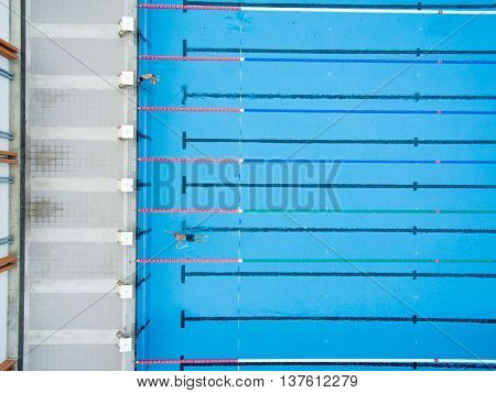 Captured top view of swimming pool and 2 swimmer