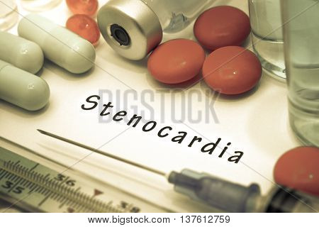 Stenocardia - diagnosis written on a white piece of paper. Syringe and vaccine with drugs.
