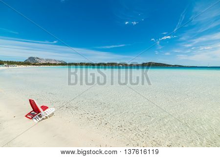 red and white beach chairs in Cala Brandinchi Sardinia