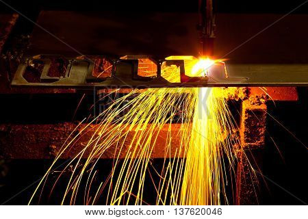 Laser Cutting Machine of metal sheet with sparks.