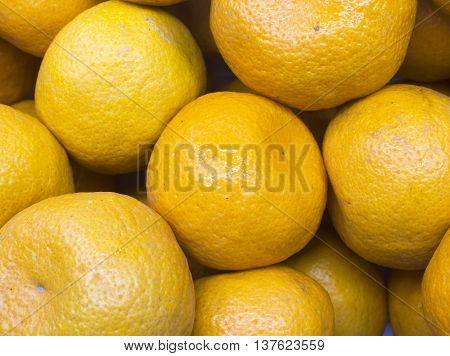 The many fresh raw orange has vitaminC for good health.
