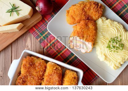 Traditional Cordon bleu with mashed potatoes on a wooden background