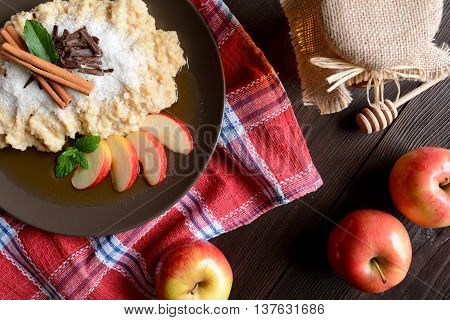 Sweet millet porridge with honey, apples and grated coconut