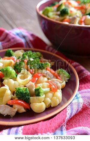 Pasta salad with chicken meat, broccoli, chilli and peppers