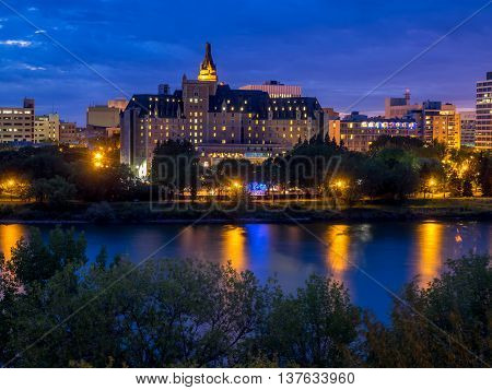 Saskatoon skyline at night along the Saskatchewan River.