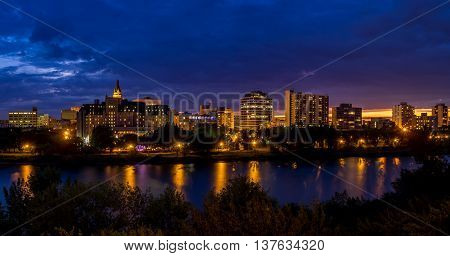 Saskatoon skyline at night along the Saskatchewan River.