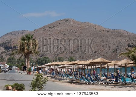 GEORGIOUPOLIS CRETE GREECE - AUGUST 5 2013: On the beach of Georgioupolis. In the past a fishing village is now quite crowded and popular resort on Crete.