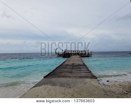 Boat on Maldives resort Island on the Pathway