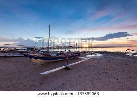 Holiday in Bali, Indonesia - Reflection Sunrise in Tanjong Benoa with boat