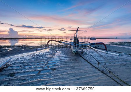 Holiday in Bali, Indonesia - Reflection Sunrise in Tanjong Benoa with boat