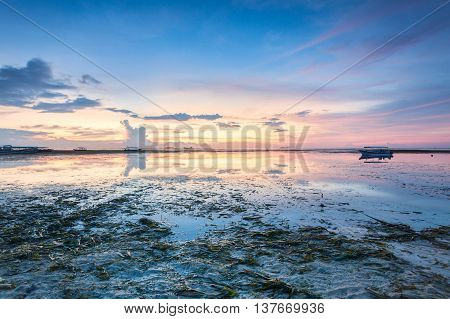 Holiday in Bali, Indonesia - Reflection Sunrise in Tanjong Benoa with boat