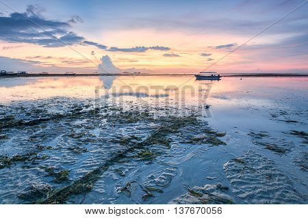 Holiday in Bali, Indonesia - Reflection Sunrise in Tanjong Benoa with boat