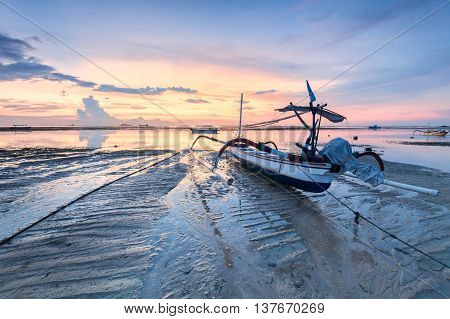 Holiday in Bali, Indonesia - Reflection Sunrise in Tanjong Benoa with boat