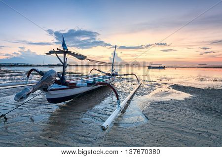 Holiday in Bali, Indonesia - Reflection Sunrise in Tanjong Benoa with boat