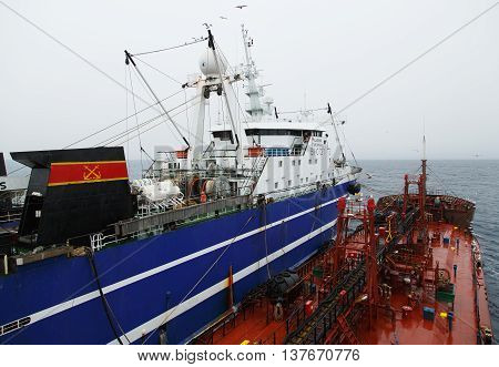 The Bering Sea Russia - Jun 18th 2016: The Bering Sea fishing seiner VLADIMIR STARZHINSKY on a mooring with the tanker Georgiy Froier.