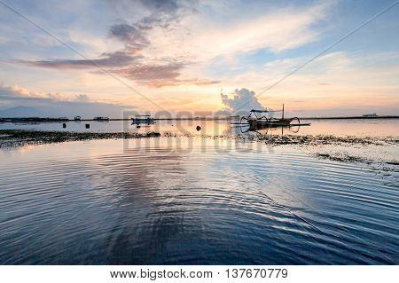 Holiday in Bali, Indonesia - Reflection Sunrise in Tanjong Benoa with boat