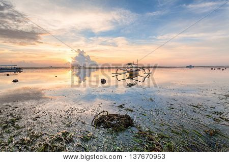 Holiday in Bali, Indonesia - Reflection Sunrise in Tanjong Benoa with boat