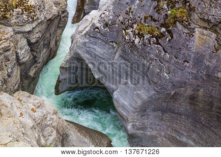 Rocks eroded by the power of quickly flowing water of the North Saskatchewan River in Alberta Canada