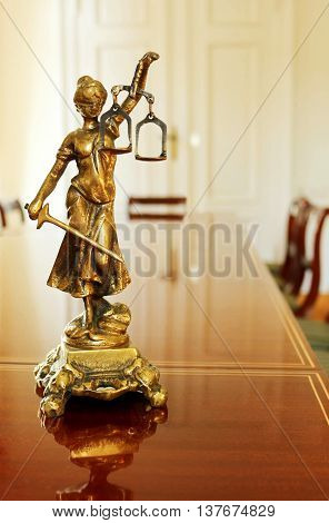 closeup of Themis in lawyer's office .
