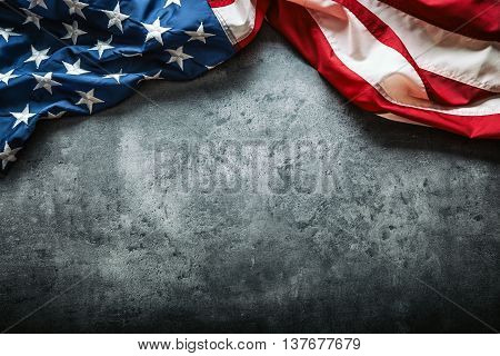 USA flag. American flag. American flag freely lying on concrete background. Close-up Studio shot. Toned Photo.
