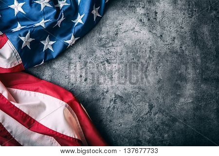 USA flag. American flag. American flag freely lying on concrete background. Close-up Studio shot. Toned Photo.