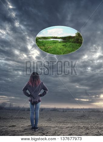 Young girld on a gloomy plain imagine a picture of a sunny plain.