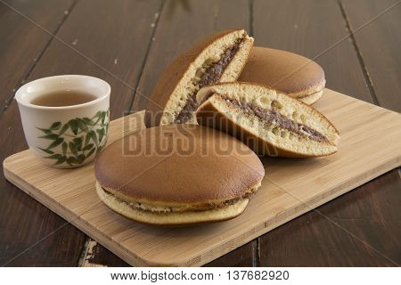 Japanese Dessert Dorayaki And Tea On Wood Board
