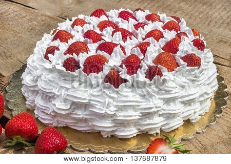 Light, delicate and tasty cream cake with fresh strawberries