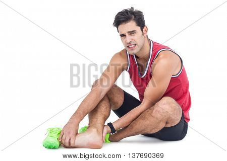 Portrait of male athlete with foot pain on isolated white background