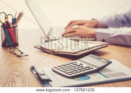 Close up of accountant or banker making calculations. Savings finances and economy concept