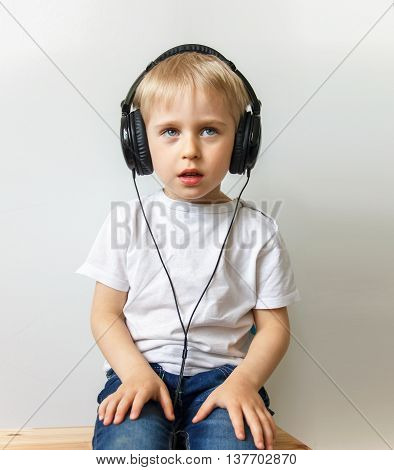 Happy Cheerful Boy With Headphones Listening To Music,