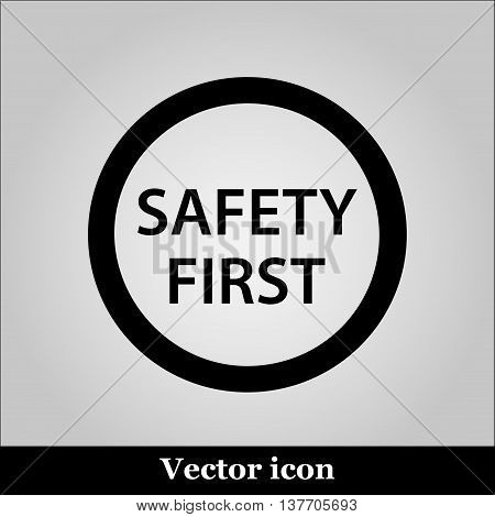 Black round safety first icon on grey background