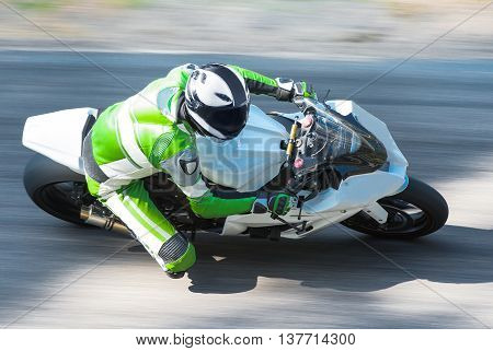 Dynamic and realistic motorbike racing on bright summer background