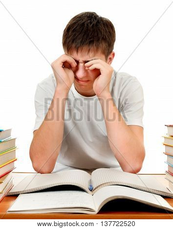 Tired Teenager Rub the Eyes on the School Desk Isolated on the White