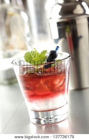 Blueberry cocktail prepared with lemon lime blueberries and vodka and decorated with mint leaves.