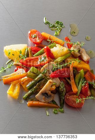 Grilled vegetables with spicy oil on a Japanese teppanyaki grill plate.