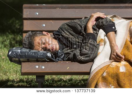 Homeless Woman Sleeping On A Bench