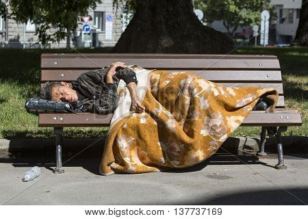 Homeless Woman Sleeping On A Bench