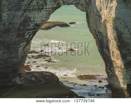 Natural arch in the famous cliff Porte d'Aval. Cote d'Albatre or Alabaster Coast. Etretat, Normandy, France
