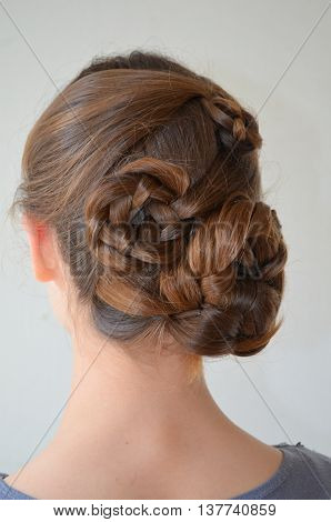 Weaving with long hair - young girl in blue on a white background