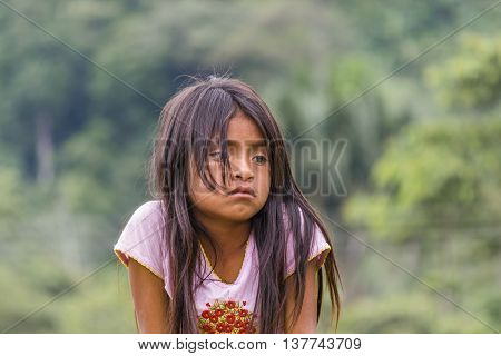 PUYO, ECUADOR, OCTOBER - 2015 - Portrait of amazonic indigenous ecuadorian kid with sad expression in Puyo Ecuador.