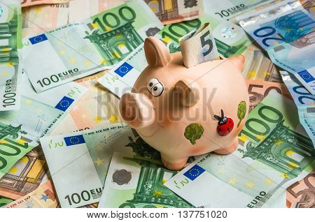 Piggy Bank In A Pile Of Euro Money