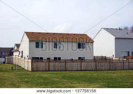 A tract home behind a tall wooden fence in the Aspen Meadows subdivision of west Joliet.