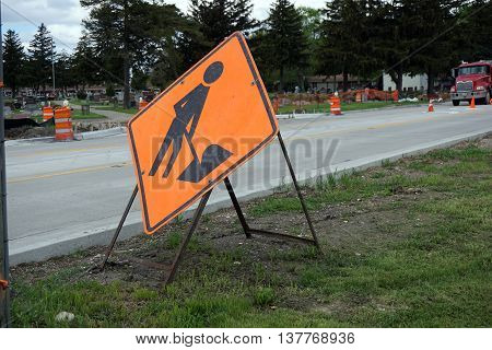 PLAINFIELD, ILLINOIS / UNITED STATES - MAY 4, 2016: An orange sign warns drivers of road construction on Renwick Road in Plainfield.