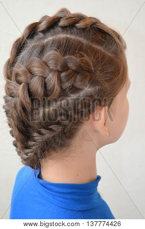 Weaving with long hair - young girl in blue on a white background